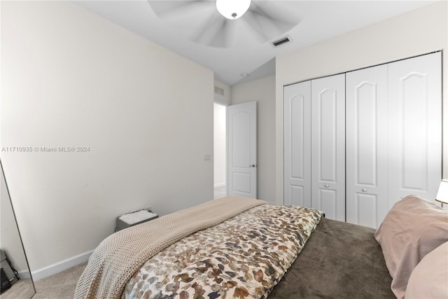 bedroom featuring light colored carpet, a closet, and ceiling fan