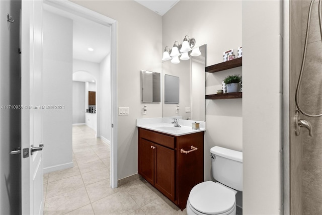 bathroom with tile patterned flooring, vanity, and toilet