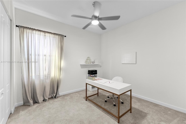 carpeted home office featuring ceiling fan