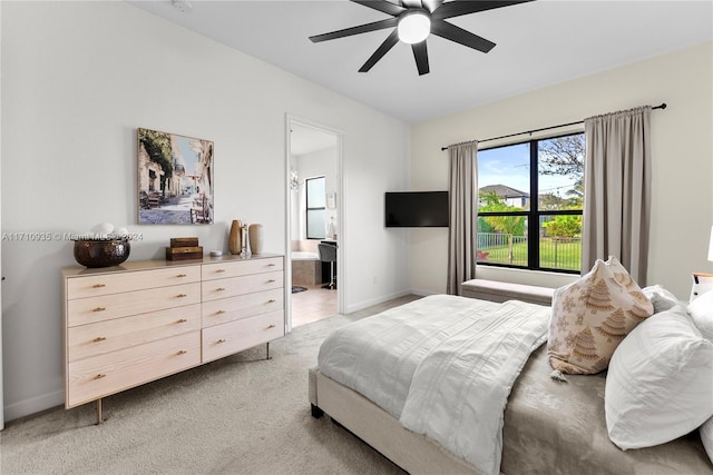 bedroom featuring ensuite bathroom, ceiling fan, and light colored carpet