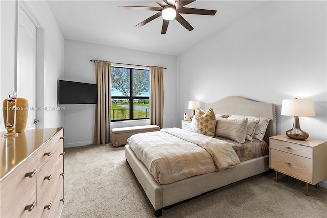 bedroom featuring ceiling fan, light colored carpet, and lofted ceiling