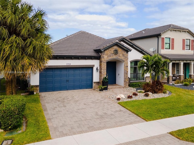 view of front of home featuring a front lawn and a garage