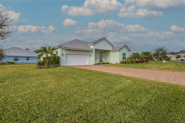 single story home featuring a garage and a front lawn