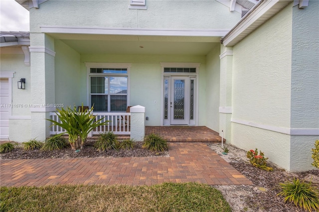 view of exterior entry featuring a porch