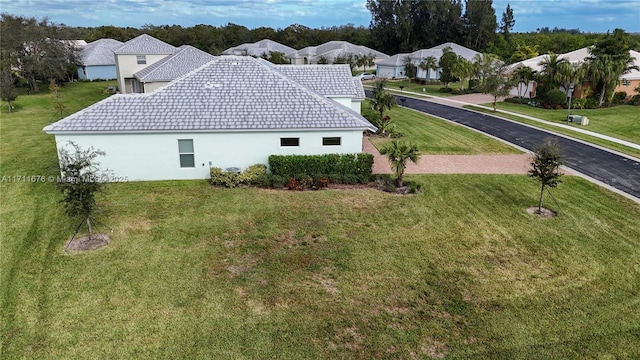 view of side of property featuring a yard