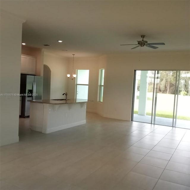 interior space with ceiling fan, sink, and light tile patterned floors