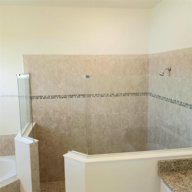 bathroom with shower with separate bathtub