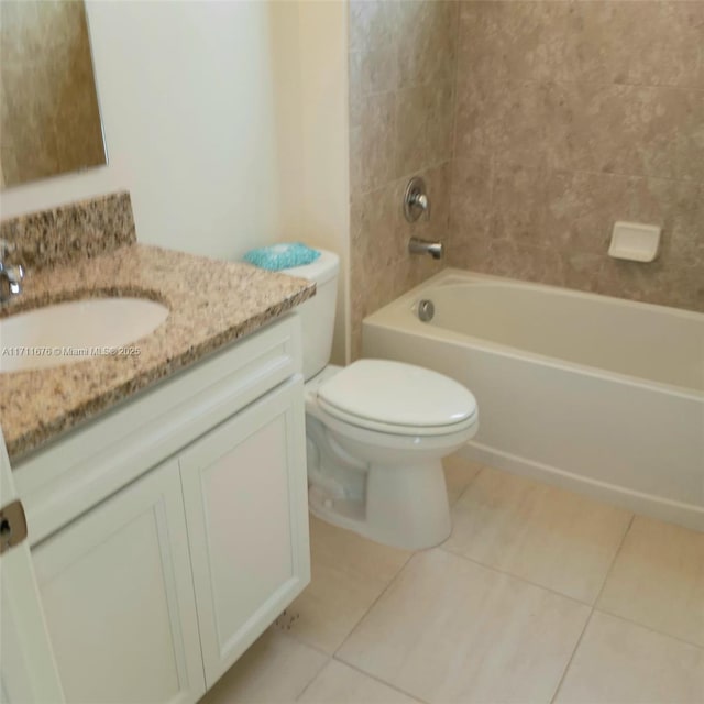 full bathroom with toilet, vanity, tile patterned floors, and tiled shower / bath combo