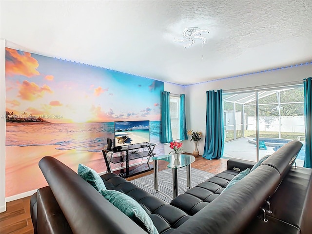 living room with hardwood / wood-style floors and a textured ceiling