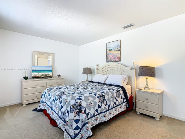 bedroom with light colored carpet