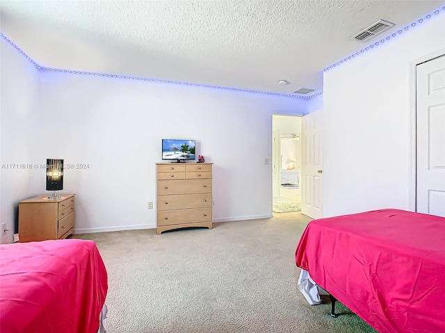 bedroom with carpet flooring and a textured ceiling