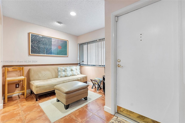 interior space featuring a textured ceiling and light tile patterned flooring