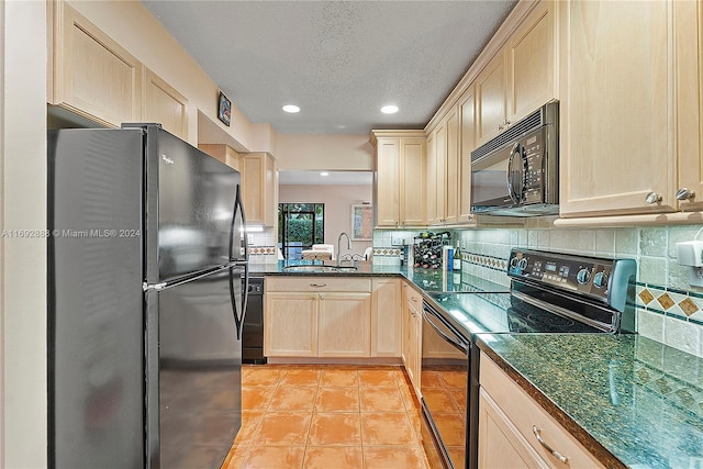 kitchen with tasteful backsplash, sink, black appliances, light brown cabinets, and light tile patterned flooring