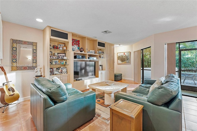 tiled living room with a textured ceiling