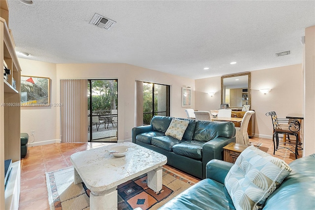 living room featuring a textured ceiling and light tile patterned flooring