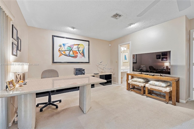 office area with light colored carpet and a textured ceiling