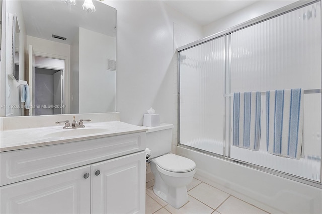 full bathroom with tile patterned floors, toilet, vanity, and combined bath / shower with glass door