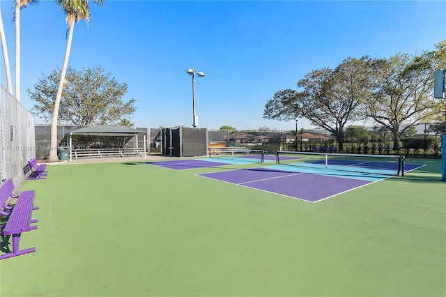 view of tennis court with basketball hoop