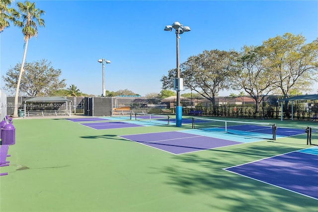 view of tennis court featuring basketball hoop