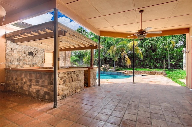 view of patio featuring an outdoor pool, ceiling fan, and outdoor dry bar