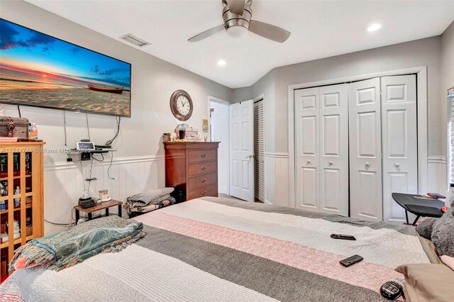 bedroom featuring ceiling fan and multiple closets