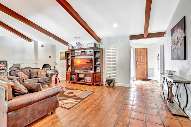 living room featuring beamed ceiling and light wood-type flooring