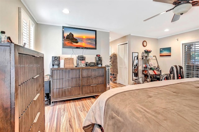 bedroom featuring multiple windows, ceiling fan, and light wood-type flooring