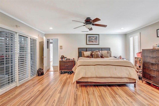 bedroom with ceiling fan, crown molding, and light hardwood / wood-style floors