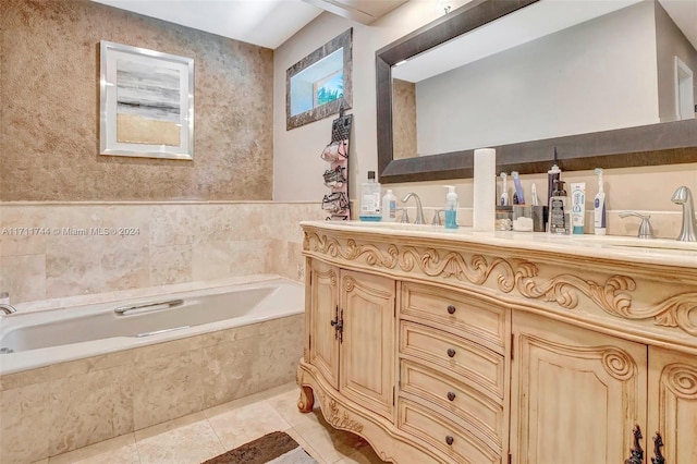 bathroom with tile patterned flooring, vanity, and a relaxing tiled tub