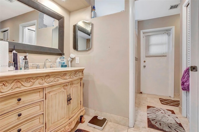 bathroom with tile patterned floors and vanity