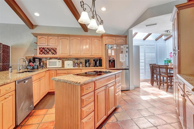 kitchen featuring light brown cabinetry, sink, pendant lighting, and appliances with stainless steel finishes