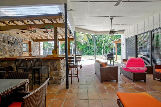 view of patio with an outdoor bar and ceiling fan