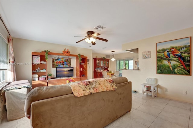 tiled living room with ceiling fan