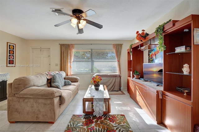 living room with ceiling fan and light tile patterned flooring