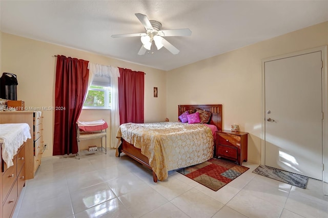 bedroom with ceiling fan and light tile patterned flooring