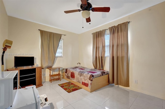 tiled bedroom with ceiling fan