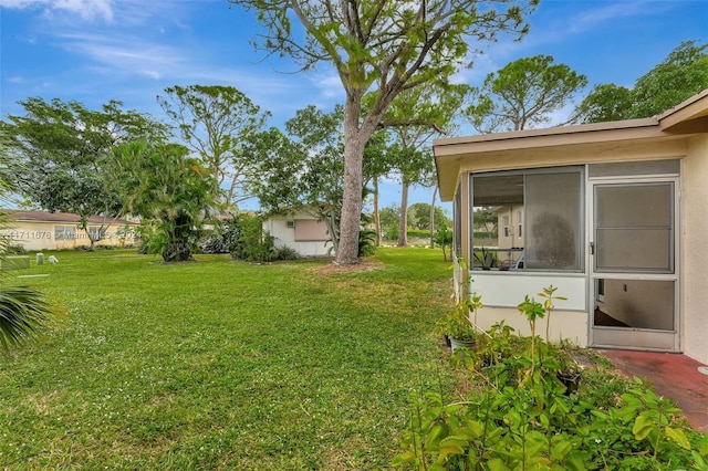 view of yard with a sunroom