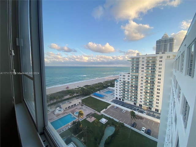 exterior space with a water view and a view of the beach