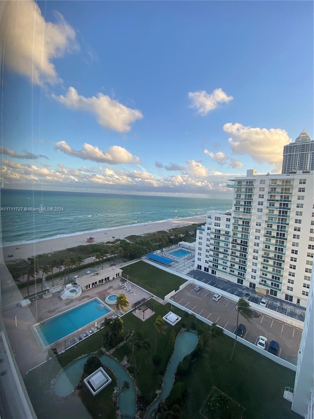 drone / aerial view with a beach view and a water view