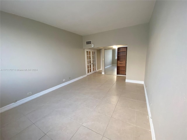 spare room featuring light tile patterned floors