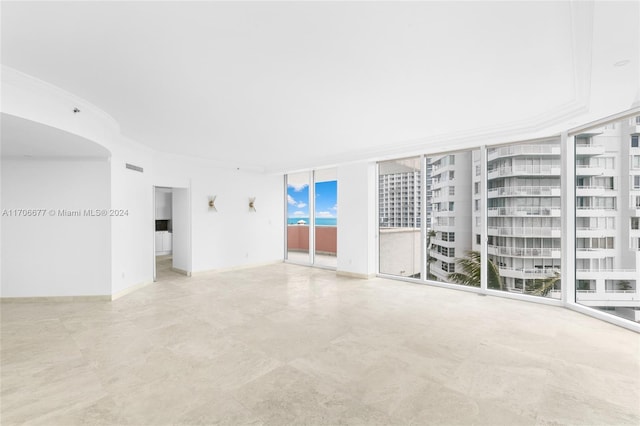 unfurnished room featuring floor to ceiling windows