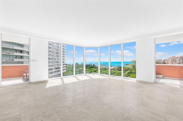 empty room with a water view and a wall of windows