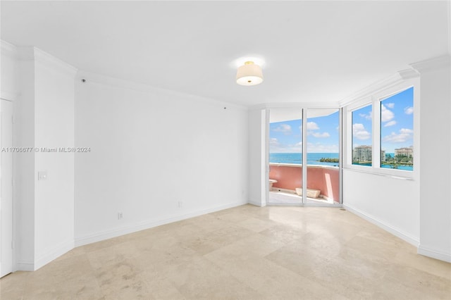 spare room featuring a water view and ornamental molding