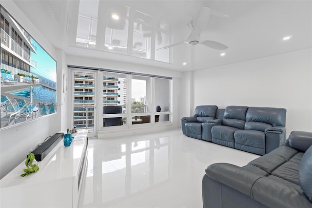 living room with ceiling fan and light tile patterned floors