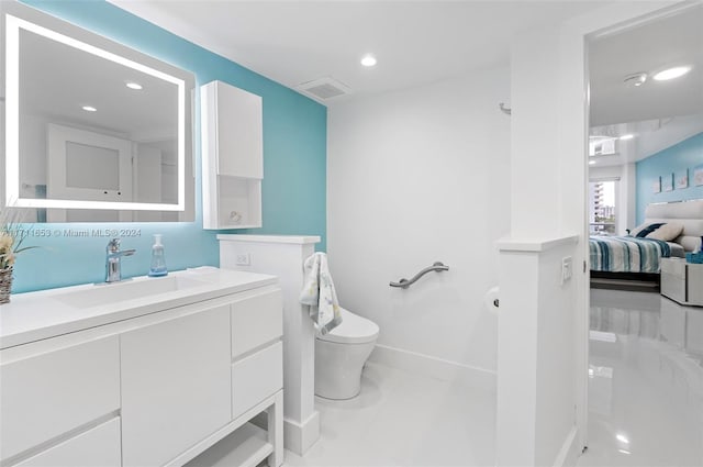 bathroom with tile patterned flooring, vanity, and toilet