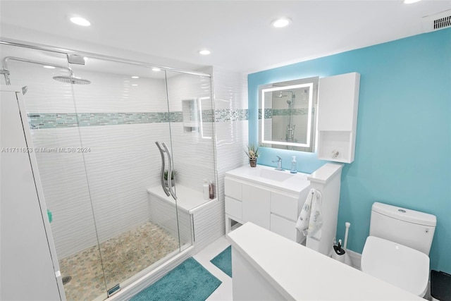 bathroom with vanity, toilet, and an enclosed shower