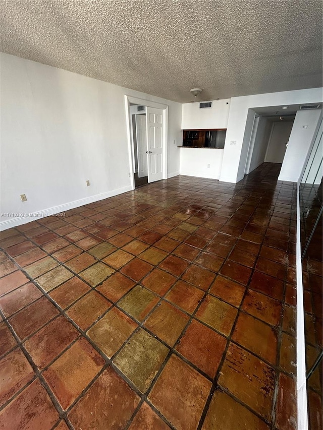 unfurnished living room featuring a textured ceiling