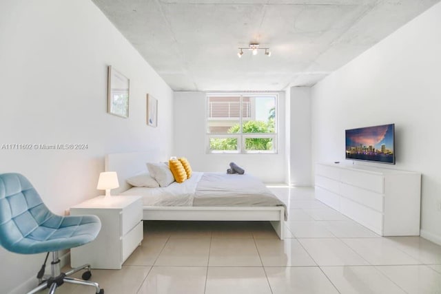 bedroom with light tile patterned floors