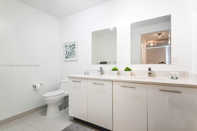 bathroom featuring tile patterned floors, vanity, and toilet