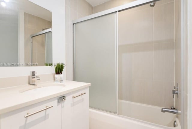 bathroom featuring vanity and enclosed tub / shower combo